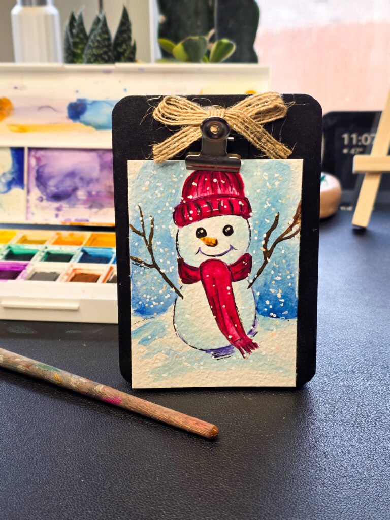 Watercolor ACEO Original Painting of a smiling snowman, 2.5x3.5 on textured watercolor paper, signed by Rosa I Evans